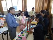 Students displaying exhibits to Admintrator Sir and Principal Madam